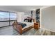 Comfortable bedroom showcasing a large window with a city view and unique marble accent wall at 205 E Harmon Ave # 1010, Las Vegas, NV 89169