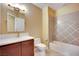 Well-appointed bathroom with a tiled shower/tub combo and vanity with a marble countertop at 21 Via Mantova # 3, Henderson, NV 89011