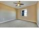 A standard, empty bedroom with a fan and a window at 21 Via Mantova # 3, Henderson, NV 89011
