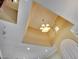Decorative lighting fixture on a beige, tray ceiling at 21 Via Mantova # 3, Henderson, NV 89011