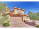 Inviting two-car garage entrance complemented by brick driveway and lush landscaping at 21 Via Mantova # 3, Henderson, NV 89011