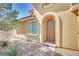 Stunning front entrance with a charming arched doorway and beautiful brick walkway at 21 Via Mantova # 3, Henderson, NV 89011