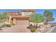 Charming two-story home featuring a tile roof, desert landscaping, and a two-car garage at 21 Via Mantova # 3, Henderson, NV 89011
