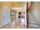 Inviting foyer featuring a staircase and an arched doorway leading to the kitchen area at 21 Via Mantova # 3, Henderson, NV 89011