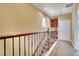 Upstairs hallway featuring wooden railing, built in cabinets and neutral paint at 21 Via Mantova # 3, Henderson, NV 89011