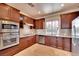 Well-lit kitchen featuring stainless steel appliances, granite countertops, and tile backsplash at 21 Via Mantova # 3, Henderson, NV 89011