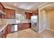 Well-equipped kitchen featuring stainless steel appliances, granite countertops, and custom cabinetry at 21 Via Mantova # 3, Henderson, NV 89011
