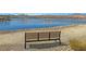 Inviting bench overlooking the serene lake and mountains, perfect for relaxing and enjoying the peaceful neighborhood views at 21 Via Mantova # 3, Henderson, NV 89011