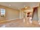Expansive living room with travertine flooring, staircase, and large window offering abundant natural light at 21 Via Mantova # 3, Henderson, NV 89011