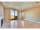 Bright living room with sliding glass doors to balcony, stone fireplace, and travertine tile floors at 21 Via Mantova # 3, Henderson, NV 89011