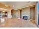 Open living space with a fireplace, tile floors, and stairway access to the upper level at 21 Via Mantova # 3, Henderson, NV 89011