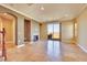 Bright living room with tile flooring, fireplace, and sliding glass doors to the balcony at 21 Via Mantova # 3, Henderson, NV 89011