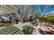 Lush backyard with mature trees, rock features, and an open patio area at 2309 Aztec Ruin Way, Henderson, NV 89044