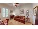 Bedroom with neutral carpet, a sofa, shuttered windows and a ceiling fan at 2309 Aztec Ruin Way, Henderson, NV 89044