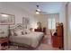 Comfortable bedroom with a wrought iron bed, shuttered window and wood furniture at 2309 Aztec Ruin Way, Henderson, NV 89044