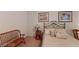 Comfortable bedroom with a wrought iron bed, bench, and decorative pillows at 2309 Aztec Ruin Way, Henderson, NV 89044