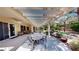 Spacious covered patio with outdoor dining set and relaxing backyard view at 2309 Aztec Ruin Way, Henderson, NV 89044
