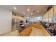 Open concept kitchen boasts granite countertops and an island with stainless steel appliances at 2309 Aztec Ruin Way, Henderson, NV 89044
