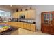 Kitchen boasts an abundance of light wood cabinetry, dark countertops and a gas range at 2309 Aztec Ruin Way, Henderson, NV 89044