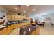 Open kitchen with granite countertops, light wood cabinetry, and eat in dining area at 2309 Aztec Ruin Way, Henderson, NV 89044