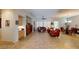 An open concept living room with tile floors offers comfortable seating, a fireplace, and natural light at 2309 Aztec Ruin Way, Henderson, NV 89044
