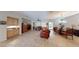 Open concept space includes a living area and dining space, complete with tile floors and comfortable seating at 2309 Aztec Ruin Way, Henderson, NV 89044