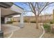 Gravel backyard featuring covered patio with a mature landscaping and privacy fence at 26 Moraine Dr, Henderson, NV 89052