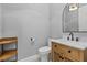 Stylish powder room featuring wood vanity, marble counters, and patterned tile floor at 26 Moraine Dr, Henderson, NV 89052