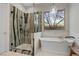 Relaxing bathroom featuring a glass shower, standalone tub, and stylish fixtures at 26 Moraine Dr, Henderson, NV 89052