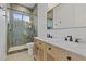 Beautiful bathroom featuring double vanity, marble counters, and a tiled walk-in shower at 26 Moraine Dr, Henderson, NV 89052