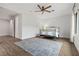 Bright bedroom with a ceiling fan, wood floor, and a large blue area rug at 26 Moraine Dr, Henderson, NV 89052