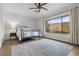 Cozy bedroom with a metal bed frame, a large window with mountain views, and a patterned area rug at 26 Moraine Dr, Henderson, NV 89052