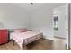 Comfortable bedroom featuring hardwood floors and view of backyard at 26 Moraine Dr, Henderson, NV 89052