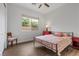 Well-lit bedroom with a window, wood floors, and a comfortable chair at 26 Moraine Dr, Henderson, NV 89052