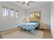 Bright bedroom with three windows, wood floors, and neutral carpet at 26 Moraine Dr, Henderson, NV 89052