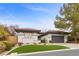 Charming single-story home boasts mature landscaping, gray stucco, and a two-car garage at 26 Moraine Dr, Henderson, NV 89052