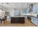 Modern kitchen features a large island, stainless steel appliances, and custom blue cabinets at 26 Moraine Dr, Henderson, NV 89052