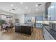 Bright kitchen features a center island with elegant marble countertop, stainless steel appliances, and blue cabinets at 26 Moraine Dr, Henderson, NV 89052