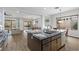 Open concept kitchen with a view of the living area and backyard, with dark wood cabinets and marble countertops at 26 Moraine Dr, Henderson, NV 89052