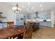 Spacious kitchen featuring blue cabinets, stainless steel appliances, a center island, and a dining table at 26 Moraine Dr, Henderson, NV 89052