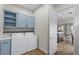 Convenient laundry room with blue cabinets, countertop, and modern appliances at 26 Moraine Dr, Henderson, NV 89052