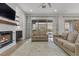 Spacious living room with fireplace, hardwood floors, and sliding glass doors at 26 Moraine Dr, Henderson, NV 89052