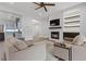 Bright, open-concept living room with fireplace, hardwood floors, and a kitchen view at 26 Moraine Dr, Henderson, NV 89052