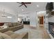 Bright, open-concept living room with fireplace, hardwood floors, and modern ceiling fan at 26 Moraine Dr, Henderson, NV 89052