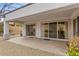 Spacious covered patio with gravel, tiled floor and sliding glass doors at 26 Moraine Dr, Henderson, NV 89052