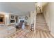 Inviting living room featuring a white brick fireplace, wood flooring, and a staircase at 2632 Matogroso Ln, Las Vegas, NV 89121