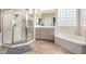 Bathroom features a shower, garden tub, and block glass windows for natural light at 2971 Fort Matanzas Ter, Henderson, NV 89052