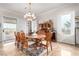 Elegant dining room with modern chandelier, large window, and sliding glass door access at 2971 Fort Matanzas Ter, Henderson, NV 89052