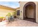 Charming courtyard entrance with decorative iron gate, sitting area, and tiled patio at 2971 Fort Matanzas Ter, Henderson, NV 89052