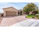 Charming single-story home featuring a well-manicured lawn, mature trees, and a brick-paved driveway leading to a two-car garage at 2971 Fort Matanzas Ter, Henderson, NV 89052